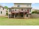 Expansive backyard view featuring a spacious deck, screened porch, and lush lawn at 8275 Majors Ridge Way, Cumming, GA 30041