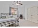 Bedroom features neutral carpet, ceiling fan, desk and ample closet space at 8275 Majors Ridge Way, Cumming, GA 30041