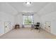 Bonus room featuring a desk, two access doors and a large window with backyard views at 8275 Majors Ridge Way, Cumming, GA 30041