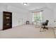 Bonus room featuring a desk, bookshelf, one access door and a large window with backyard views at 8275 Majors Ridge Way, Cumming, GA 30041