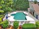 Community pool with lounge chairs and umbrellas, surrounded by landscaping at 8275 Majors Ridge Way, Cumming, GA 30041