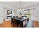 Elegant dining room featuring hardwood floors, a modern chandelier, and natural light at 8275 Majors Ridge Way, Cumming, GA 30041