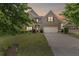 Charming two-story home with well-manicured lawn, two-car garage, and attractive architectural details at 8275 Majors Ridge Way, Cumming, GA 30041