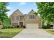 Two-story home featuring a brick and siding facade, well-manicured lawn, and two-car garage at 8275 Majors Ridge Way, Cumming, GA 30041