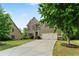 Beautiful two-story home with a well-manicured lawn, brick and siding, and attached two-car garage at 8275 Majors Ridge Way, Cumming, GA 30041