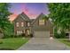 Two-story home featuring a brick and siding facade, well-manicured lawn, and two-car garage at 8275 Majors Ridge Way, Cumming, GA 30041