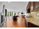 Open-concept kitchen with stainless steel appliances, granite countertops, and a center island at 8275 Majors Ridge Way, Cumming, GA 30041
