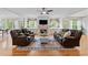 A spacious living room features hardwood floors, a fireplace, and comfortable leather seating at 8275 Majors Ridge Way, Cumming, GA 30041