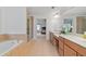 A bright main bathroom with double sinks, tile flooring, soaking tub, and glass enclosed shower at 8275 Majors Ridge Way, Cumming, GA 30041