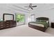 Spacious main bedroom suite features tray ceiling, and a large window with natural light at 8275 Majors Ridge Way, Cumming, GA 30041