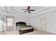 A spacious main bedroom features tray ceilings, neutral carpet, and ample natural light at 8275 Majors Ridge Way, Cumming, GA 30041