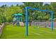 Community playground with swings and climbing structure on green turf at 8275 Majors Ridge Way, Cumming, GA 30041