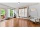 A bright sitting room features hardwood floors, natural light, and a modern chair at 8275 Majors Ridge Way, Cumming, GA 30041