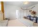Bright bedroom features a ceiling fan, white walls, and doorway leading to an ensuite bathroom at 1005 Glen Ivy, Marietta, GA 30062