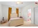 Cozy bedroom featuring a classic bed frame, a window with curtains, and an attached bathroom at 1005 Glen Ivy, Marietta, GA 30062
