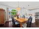 Dining area with a large window, wooden table, and adjacent kitchen for easy entertaining at 1005 Glen Ivy, Marietta, GA 30062