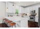 Modern kitchen with white cabinets, a marble counter top, and stainless steel appliances at 1005 Glen Ivy, Marietta, GA 30062