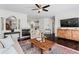 Inviting living room with a fireplace, dark hardwood floors, a ceiling fan, and modern decor at 1005 Glen Ivy, Marietta, GA 30062