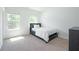 Bedroom with neutral carpet, a large window and a modern bed frame at 2649 Ogden Trl, Buford, GA 30519
