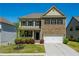Charming two-story home featuring a brick facade, well-manicured lawn, and a covered front porch at 2649 Ogden Trl, Buford, GA 30519