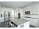 Open kitchen features granite counters, stainless appliances and a large center island with seating at 2649 Ogden Trl, Buford, GA 30519