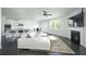 Open-concept living room with fireplace, comfortable white seating, and adjacent kitchen at 2649 Ogden Trl, Buford, GA 30519