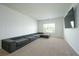 Bright living room with large sectional sofa, neutral carpet, and large window at 2649 Ogden Trl, Buford, GA 30519