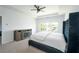 Bright main bedroom featuring neutral carpet, fireplace, and a large upholstered bed at 2649 Ogden Trl, Buford, GA 30519