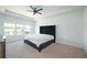 Bright main bedroom featuring neutral carpet, a modern fan and a large upholstered bed at 2649 Ogden Trl, Buford, GA 30519