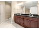 Bathroom vanity with dark cabinets, double sinks, granite counters, and tile flooring at 2865 Lenox Ne Rd # 504, Atlanta, GA 30324