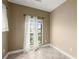 Bedroom features neutral paint, tile floors, base molding and a window with sheer curtains at 2865 Lenox Ne Rd # 504, Atlanta, GA 30324