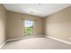 Bedroom features neutral carpeting, base molding and a window overlooking a green landscape at 2865 Lenox Ne Rd # 504, Atlanta, GA 30324