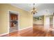 Open concept dining room flowing into kitchen featuring hardwood floors, chandelier and neutral paint at 2865 Lenox Ne Rd # 504, Atlanta, GA 30324