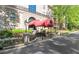 Elegant entrance with a red awning, landscaping, and stone columns on a sunny day at 2865 Lenox Ne Rd # 504, Atlanta, GA 30324