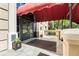 Close up of the entrance door with a red canopy, potted plants, and tile flooring at 2865 Lenox Ne Rd # 504, Atlanta, GA 30324