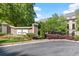 Elegant entrance to Le Chateau, featuring lush landscaping and a stately sign at 2865 Lenox Ne Rd # 504, Atlanta, GA 30324