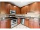 Galley style kitchen features stainless steel appliances, granite countertops, and wooden cabinetry at 2865 Lenox Ne Rd # 504, Atlanta, GA 30324