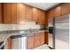 Galley style kitchen with stainless steel appliances, granite countertops, and wooden cabinetry at 2865 Lenox Ne Rd # 504, Atlanta, GA 30324