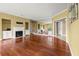 Living room with hardwood floors, a fireplace, and a mirrored wall with natural light at 2865 Lenox Ne Rd # 504, Atlanta, GA 30324