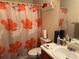 Functional bathroom features a shower with floral curtain, mirror, and essential fixtures at 4206 Shoreside Cir, Snellville, GA 30039