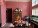 Formal dining room boasting a classic chandelier and pink painted walls at 4206 Shoreside Cir, Snellville, GA 30039