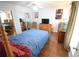 Comfortable bedroom with a large bed, mirrored closet doors, and hardwood floors at 574 Trillum Sw Ct, Marietta, GA 30008