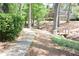 Exterior shot of home showing wooded pathway with a small bridge and mature trees at 574 Trillum Sw Ct, Marietta, GA 30008