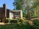 Charming two-story condo featuring a brick chimney, lush landscaping and serene surroundings at 574 Trillum Sw Ct, Marietta, GA 30008