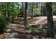 Beautiful wooded pathway with mature trees, a small creek and a charming footbridge leading to homes at 574 Trillum Sw Ct, Marietta, GA 30008