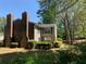Charming two-story condo featuring a brick chimney, lush landscaping and serene surroundings at 574 Trillum Sw Ct, Marietta, GA 30008