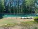 Outdoor tennis court surrounded by lush landscaping, perfect for sports enthusiasts at 574 Trillum Sw Ct, Marietta, GA 30008