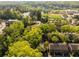 Scenic aerial view of townhomes surrounded by lush trees near a baseball field and other community amenities at 6700 Roswell Rd # 19F, Atlanta, GA 30328