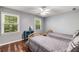 Bedroom features twin beds, wood floors, two windows with natural light and a ceiling fan at 6700 Roswell Rd # 19F, Atlanta, GA 30328