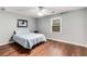 Bedroom with a light blue quilt, ceiling fan, wood floors and natural light from a window at 6700 Roswell Rd # 19F, Atlanta, GA 30328